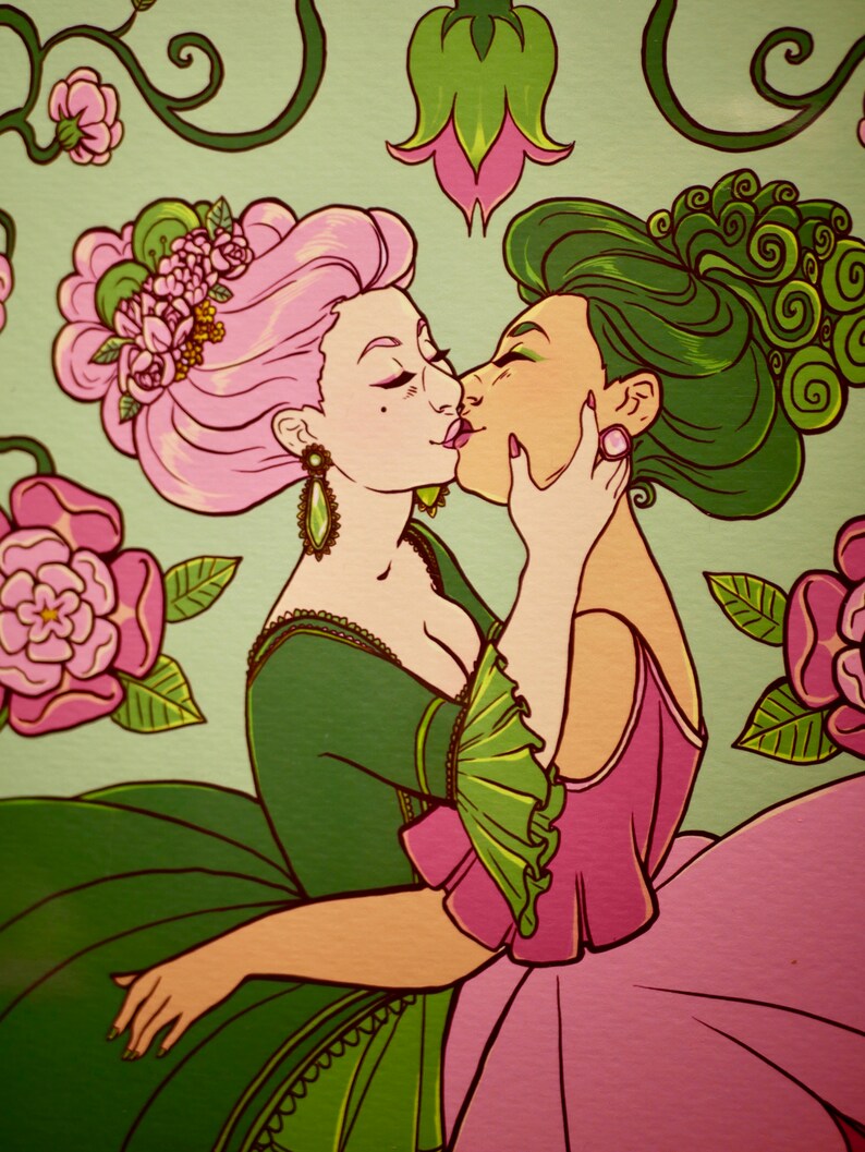 May include: Two women in elaborate dresses with pink and green floral details are kissing. The woman on the left has pink hair and a green dress, while the woman on the right has green hair and a pink dress. They are surrounded by green vines and pink flowers.