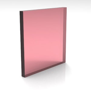 May include: A rectangular, translucent, pink-colored object with dark brown edges. The object is standing upright and appears to be made of glass or a similar material. The surface reflects light, creating a glossy appearance.