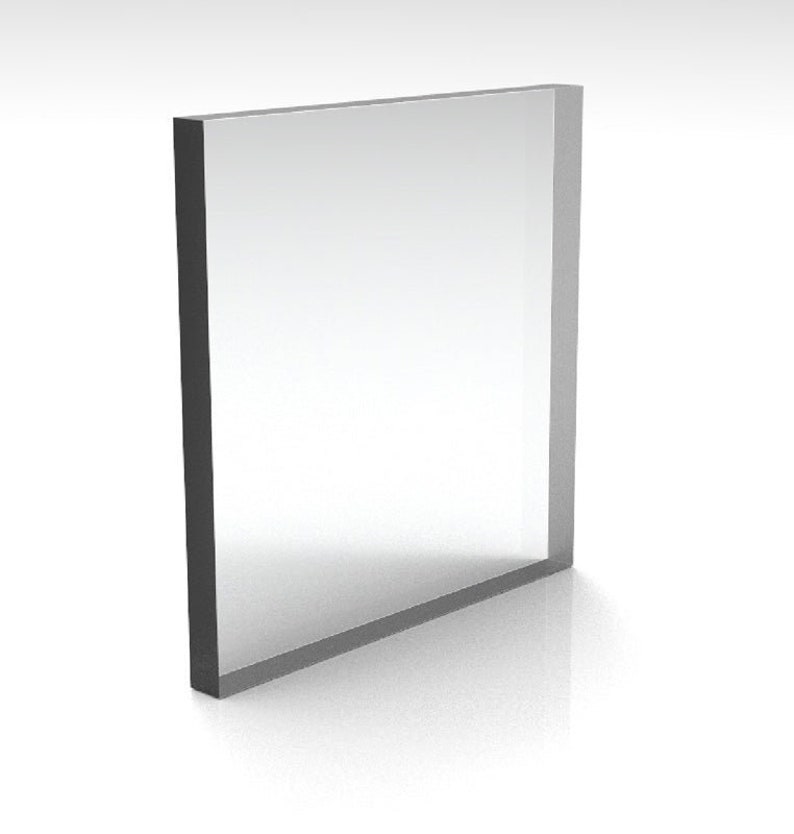 May include: A clear, rectangular acrylic block with a dark gray border. The transparent center reflects light, creating a bright, minimalist aesthetic. The block is standing upright, casting a subtle shadow.