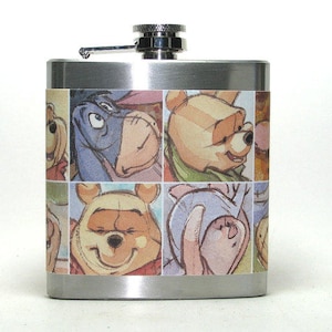 Puede incluir: Una petaca de acero inoxidable con un diseño de Winnie the Pooh y sus amigos. La petaca tiene una tapa plateada y un diseño colorido de Winnie the Pooh, Piglet, Eeyore y Tigger.
