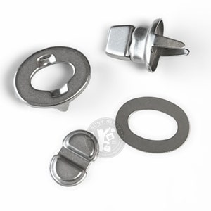 May include: Set of four silver metal snap fasteners for leather craft projects. The set includes two round pieces, one oval piece, and one piece with a square top and a pointed bottom.
