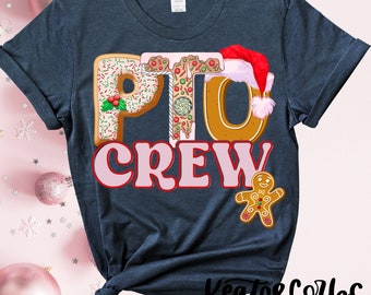 May include: A dark blue t-shirt with the words "PTO CREW" in pink and white letters. The letters are decorated with gingerbread cookie designs and red and green sprinkles. A gingerbread man cookie is in the bottom right corner.