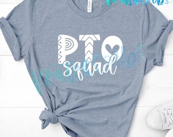 May include: A light blue t-shirt with the words "PTO squad" in white and blue script. The letters "PTO" are stylized with decorative elements, including a heart. The shirt is knotted at the waist.