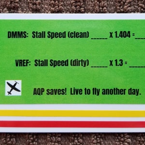May include: A green card with black text and a small black airplane icon. The text reads "DMMS: Stall Speed (clean) ____ x 1.404 = ____" and "VREF: Stall Speed (dirty) ____ x 1.3 = ____". The bottom of the card reads "AQP saves! Live to fly another day."