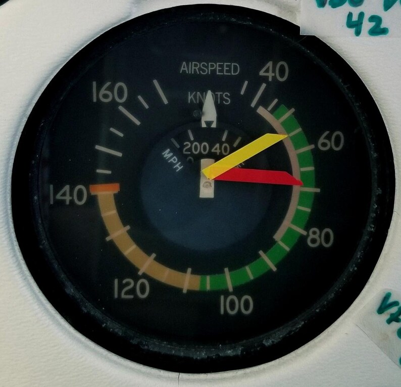 May include: A black and white airspeed indicator with a yellow and red needle. The gauge reads 40 knots and 40 mph. The gauge is labeled "airspeed" and "knots".