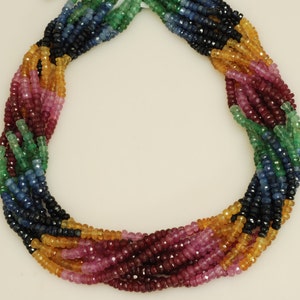 May include: A multi-strand necklace made of faceted gemstone beads in shades of blue, green, red, and yellow. The beads are arranged in a twisted pattern.