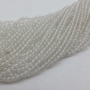 May include: A strand of clear glass beads, perfect for jewelry making or crafting projects.