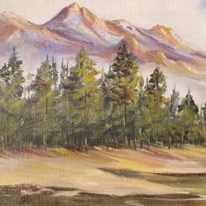 May include: A painting of a mountain range with snow-capped peaks in the background. A forest of pine trees is in the foreground. The sky is a light blue with some clouds.