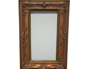 May include: Ornate rectangular mirror with a gold-toned, detailed frame. The frame features intricate carvings and a rectangular mirror surface. The text "Vintage L.A. Furniture" is at the bottom right.