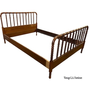 May include: A vintage wooden bed frame with a warm brown finish. The headboard and footboard feature a spindle design, adding a classic touch. The bed frame is constructed with sturdy wooden rails and legs, showcasing a timeless aesthetic.