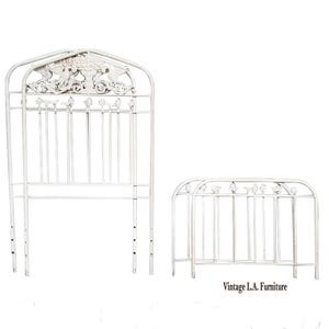 May include: A set of two off-white metal headboards featuring vertical bars and decorative top panels with bird and floral motifs. The taller headboard has an arched top, while the shorter one has a rounded top. Text reads Vintage L.A. Furniture.