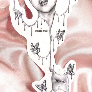 May include: A black and white line drawing of a face with dripping paint and butterflies. The text "Clinggo artist" is at the bottom of the image.