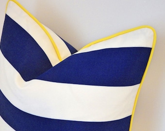 May include: A blue and white striped pillow with a yellow trim. The pillow is made of a soft, comfortable fabric and has a classic striped pattern.