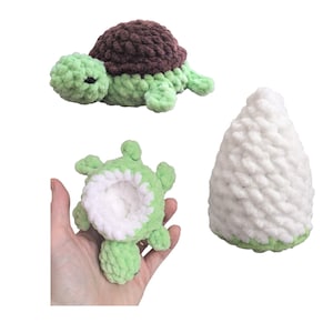 May include: A green and brown crocheted turtle toy with a white crocheted shell. The turtle is shown in two positions, one with the shell on and one with the shell off.