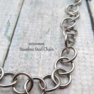 May include: A silver stainless steel chain with a 10x10mm link size. The chain has a t-bar clasp.