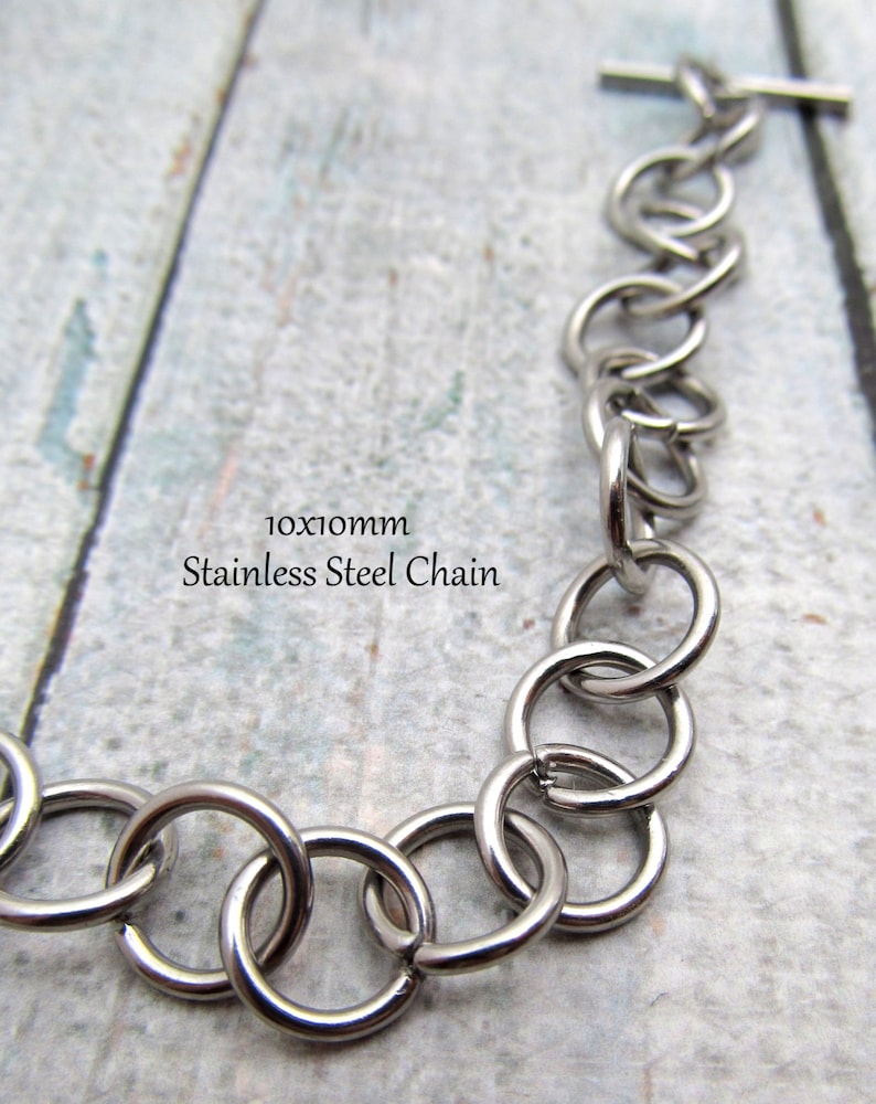 May include: A silver stainless steel chain with a 10x10mm link size. The chain has a t-bar clasp.