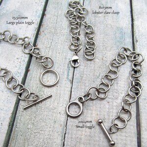 May include: Three different types of metal clasps for jewellery making. A large plain toggle clasp measures 23.5x2mm, a small toggle clasp measures 20x4mm, and a lobster claw clasp measures 8x13mm.