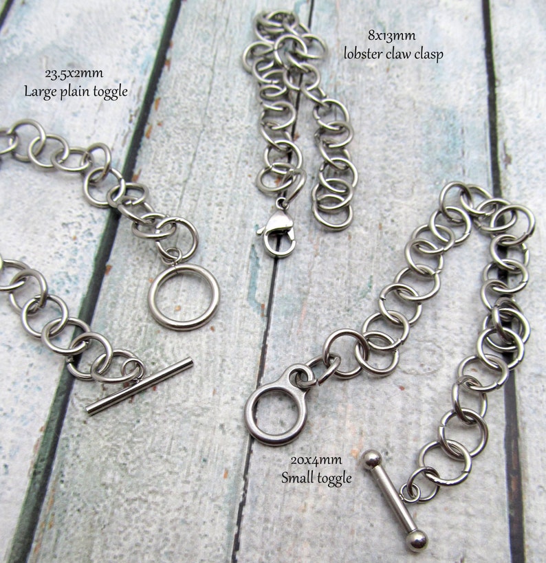 May include: Three different types of metal clasps for jewellery making. A large plain toggle clasp measures 23.5x2mm, a small toggle clasp measures 20x4mm, and a lobster claw clasp measures 8x13mm.