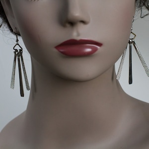 Three spoked, textured silver dangle earrings made with repurposed pieces