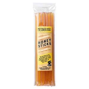May include: A clear plastic package containing wildflower honey sticks. The label reads "Messner Bee Farm Honey Sticks Pure Honey." The package contains 16 sticks, each with 8 grams of honey. The text on the label also suggests using the honey sticks in coffee or tea.