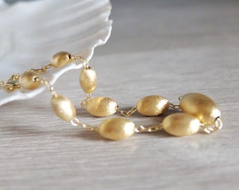Bracelet  with brushed gold oval and round elements