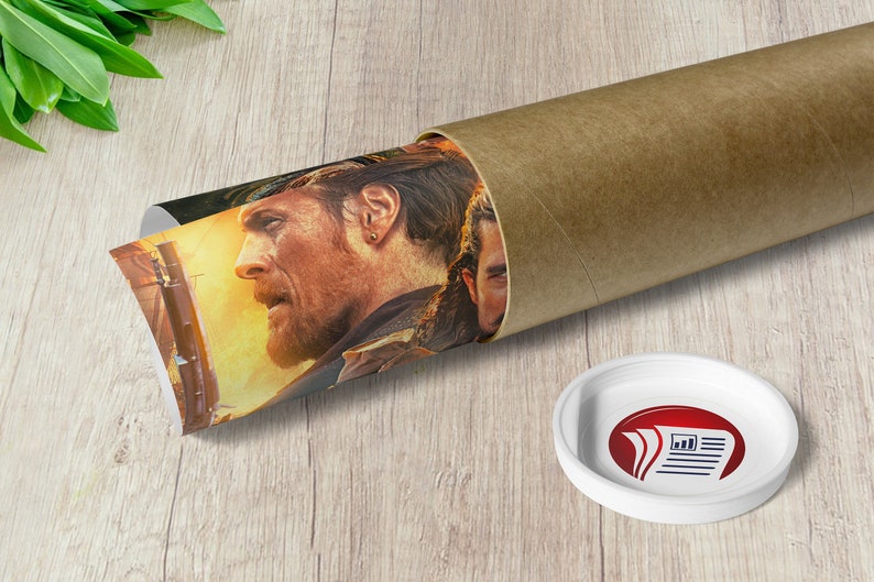 May include: A rolled-up poster featuring a close-up of a man's face with a beard and a gold earring. The poster is partially unrolled and shows a scene with a fiery background. The poster is in a brown cardboard tube.