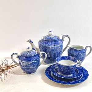 Part of an antique blue and white tea set, teapot, 6 plates, tea cup