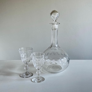 Antique wine decanter with stopper and two wine glasses, early 20th c