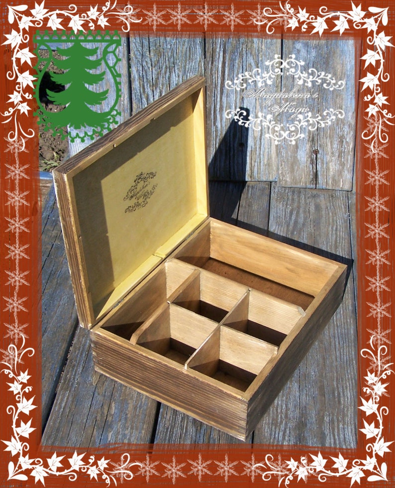 May include: A wooden box with a hinged lid and six compartments. The box is stained a dark brown colour and has a light brown interior. The lid has a decorative design on the inside.
