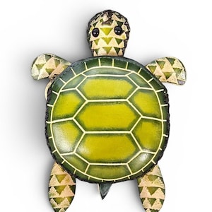 May include: A handcrafted turtle-shaped item with a green and yellow shell design. The turtle has a detailed head and flippers, with a textured pattern. The shell features a hexagonal pattern. The item is likely a decorative piece or a small accessory.