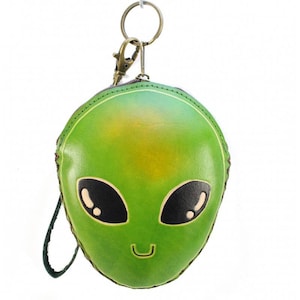 May include: Green leather coin purse shaped like an alien face with black eyes and a smiling mouth. The purse has a zipper closure and a key ring.