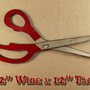 May include: Large red and white painted metal scissors, 32 inches wide and 12 inches tall.