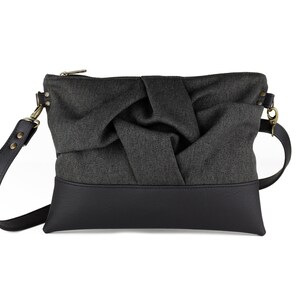 small charcoal black crossbody bag with hand-smocked pleated detail and black vegan leather bottom and adjustable strap; front view