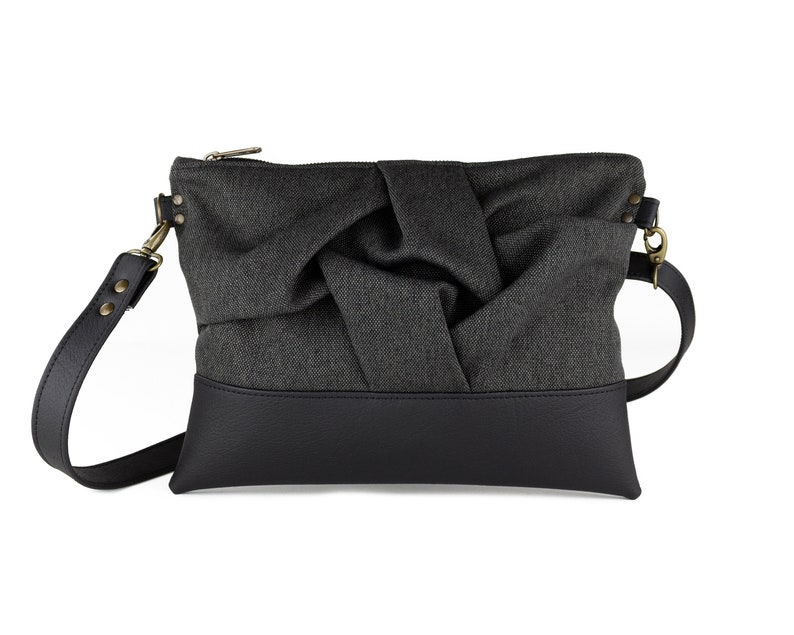 small charcoal black crossbody bag with hand-smocked pleated detail and black vegan leather bottom and adjustable strap; front view