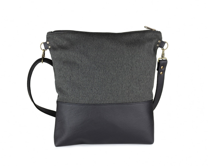 charcoal black medium-sized crossbody bag with hand-smocked pleated detail and  black vegan leather bottom and adjustable strap; back view (without smocked detail)