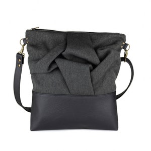 charcoal black medium-sized crossbody bag with hand-smocked pleated detail and  black vegan leather bottom and adjustable strap; front view