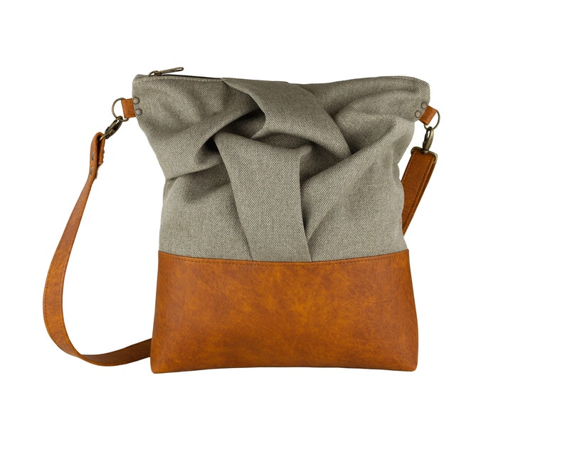 brown medium-sized crossbody bag with hand-smocked pleated detail and brown vegan leather bottom and adjustable strap; front view