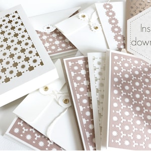 May include: A collection of white and tan stationery items, including cards, envelopes, and a box. The cards and box feature a decorative cut-out pattern. The text "Instant download!" is visible on a hexagonal tag.