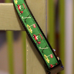 Adjustable golf themed green dog collar with cute little golf carts.