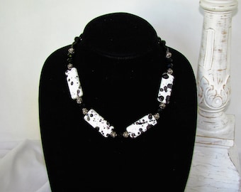 Black and white necklace with a bit of abstract design.  Rectangular white beads with a splash of black.  Special occasion necklace.
