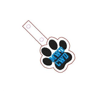 May include: A black paw print with the text "MWD CWD" in blue lettering. The paw print is attached to a white strap with two holes at the top.
