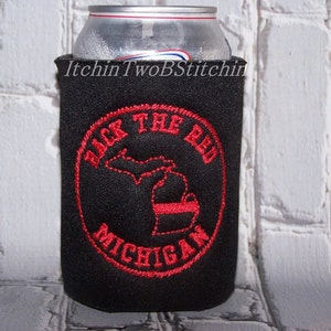 May include: Black neoprene can cooler with red embroidered text and an outline of the state of Michigan. The text reads "Back the Red Michigan".