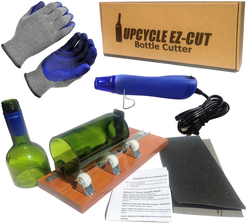 May include: A glass bottle cutter kit with a wooden base, a glass bottle, a heat gun, two pairs of gloves, and sandpaper. The kit includes instructions on how to use the bottle cutter.