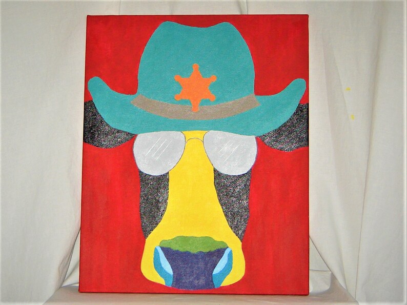 May include: A colorful painting of a cow wearing a turquoise cowboy hat with a sheriff's star, sunglasses, and a yellow face. The background is red.