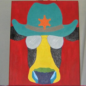 May include: A painting of a cow wearing a blue and green cowboy hat with a yellow star on the front. The cow's eyes are covered by silver sunglasses. The background is red.