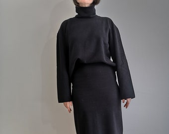 Women solid two-piece set in black. Turtleneck longsleeve sweater. Bodycon midi black skirt.