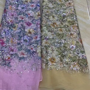 May include: Two pieces of floral embroidered fabric with sequins. The fabric on the left is pink and the fabric on the right is beige.