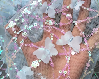 May include: Light blue tulle fabric with iridescent sequins and white butterfly appliques.
