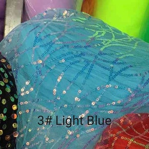 May include: Light blue tulle fabric with iridescent sequins in a geometric pattern. The fabric is labeled "3# Light Blue".