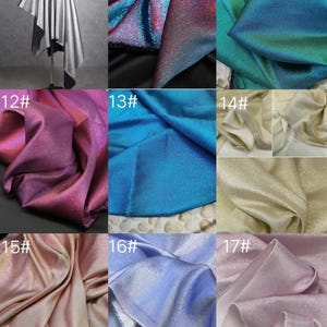 May include: Nine iridescent fabric swatches in various colors, including silver, blue, pink, and gold. The swatches are arranged in a grid pattern.